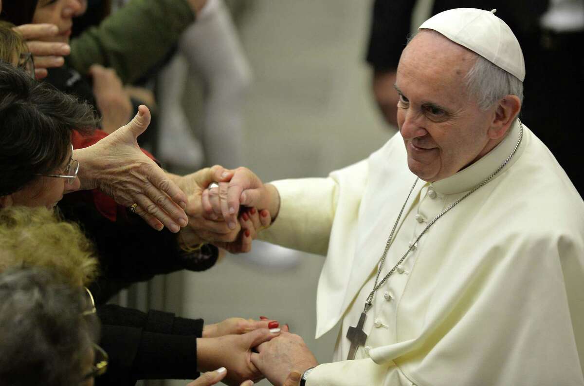 Pope Francis greets the crowd at his audience with Vatican employees after his Christmas speech.