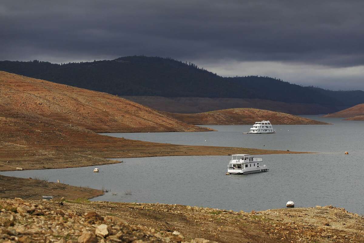House boats sit idle in the low water of Lake Oroville Nov. 29, 2014 in Oroville, Calif. Figures released Tuesday, Jan. 6, 2014, by the State Water Resources Control Board show California residents used 9.8 percent less water in November 2014 than in the same month in 2013.