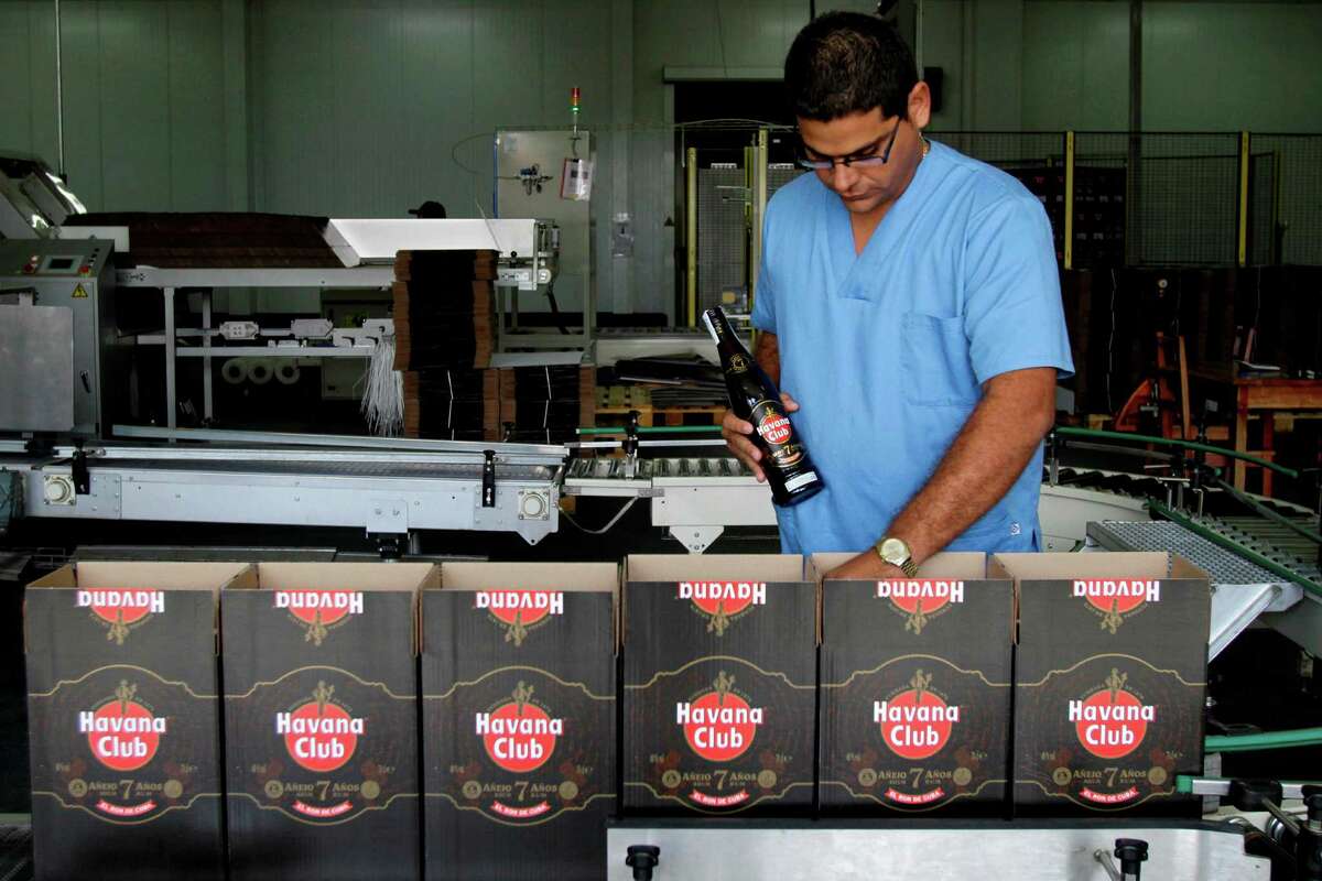 In this Oct. 22, 2010, file photo, a worker checks the production of Havana Club rum at the company's factory in Havana, Cuba. U.S. rum aficionados are abuzz over the potential for making Cuba Libres with Cuban rum, now that Americans visiting the Caribbean island will be allowed to bring home rum distilled there for the first time since the embargo took effect 55 years ago. Meanwhile, industry titan Bacardi, which was driven from the island by the 1959 Castro revolution, says it’s waiting to see what the impacts of thawing U.S.-Cuba relations will be.