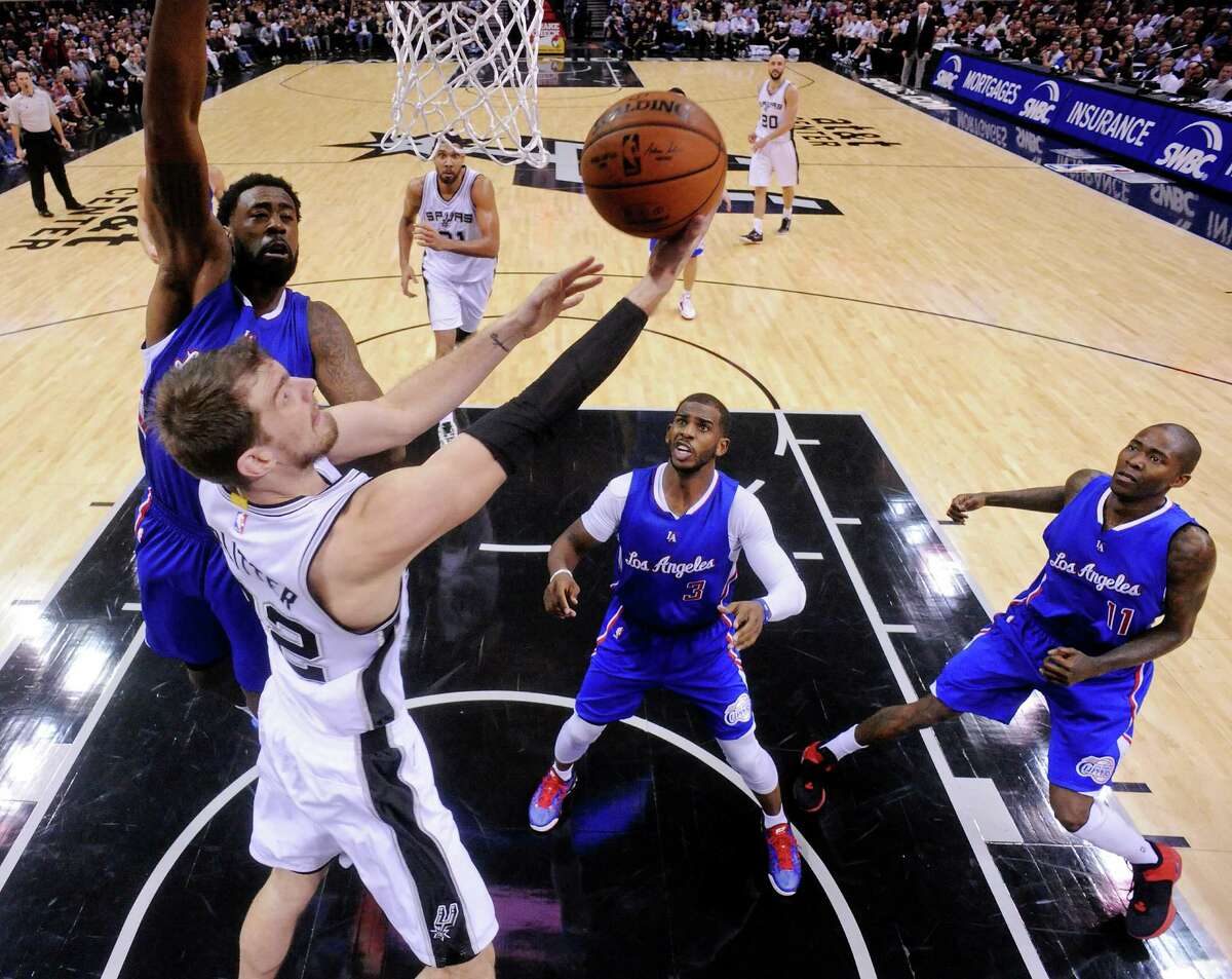 San Antonio Spurs' Tiago Splitter shoots around Los Angeles Clippers' DeAndre Jordan (left) as Chris Paul and Jamal Crawford look on during second half action Monday Dec. 22, 2014 at the AT&T Center. The Spurs won 125-118.