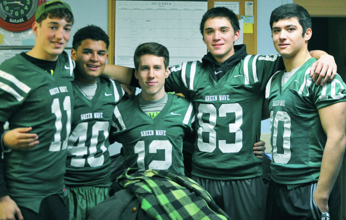 Delivering coats to the Thrift Mart of New Milford are New Milford High School football players, from left to right, Danny Flynn, Andre Taylor, Jacob Plancon, Patrick Ryan and Chris Ryan. December 2014 Courtesy of Beverly Ryan