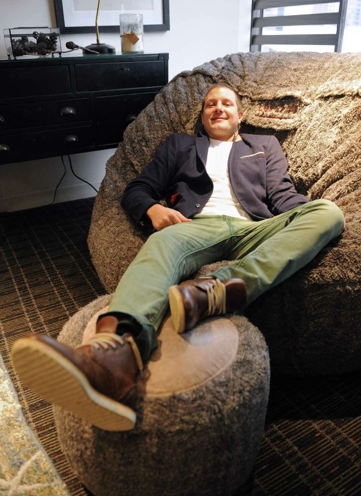 Lovesac founder Shawn Nelson lounges in a Lovesac at the new Lovesac Headquarters at 2 Landmark Square in downtown Stamford, Conn. Tuesday, Dec. 23, 2014. Lovesac and its team of about 50 employees moved from the undersized office on Canal Street the new, spacious Landmark Square location about a month ago. The new office and showroom incorporates Lovesac's "sactional" modular furniture for employees' work spaces.