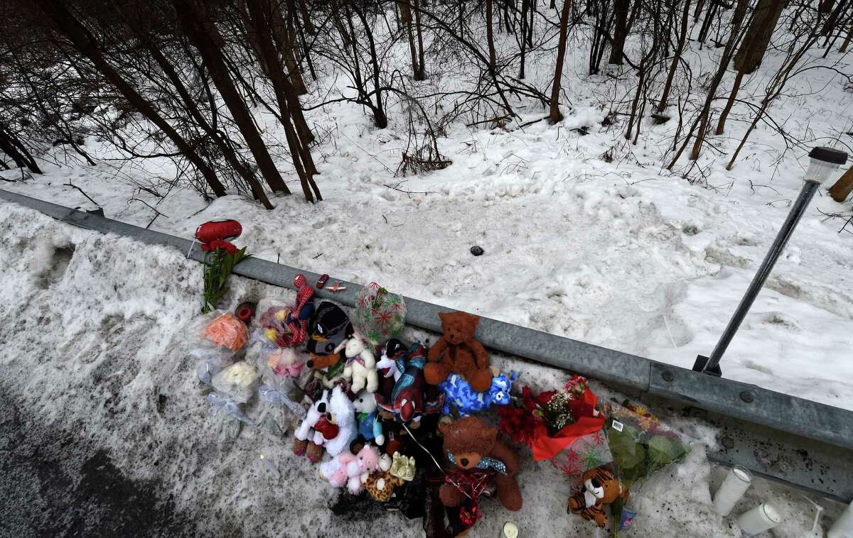 A memorial is set up Tuesday Dec. 23, 2014, at the site where the body of Kenneth White was found over the guard rail across the street from his home on Thacher Park Road in Knox, N.Y. (Skip Dickstein/Times Union archive)