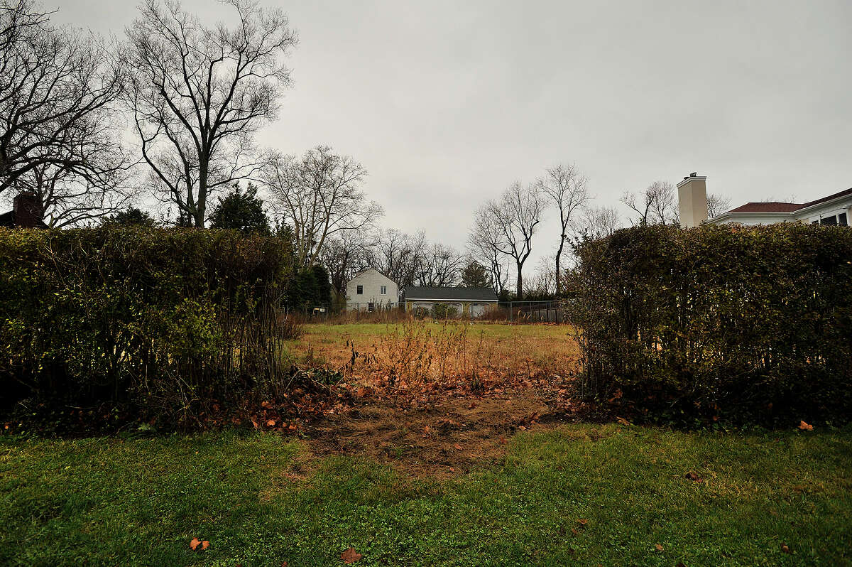 An empty lot sits vacant at the end of Shippan Avenue in Stamford, Conn., on Tuesday, Dec. 23, 2014. The lot is all that remains after a fire swept through a house there and killed three children and two adults on Christmas Day in 2011.