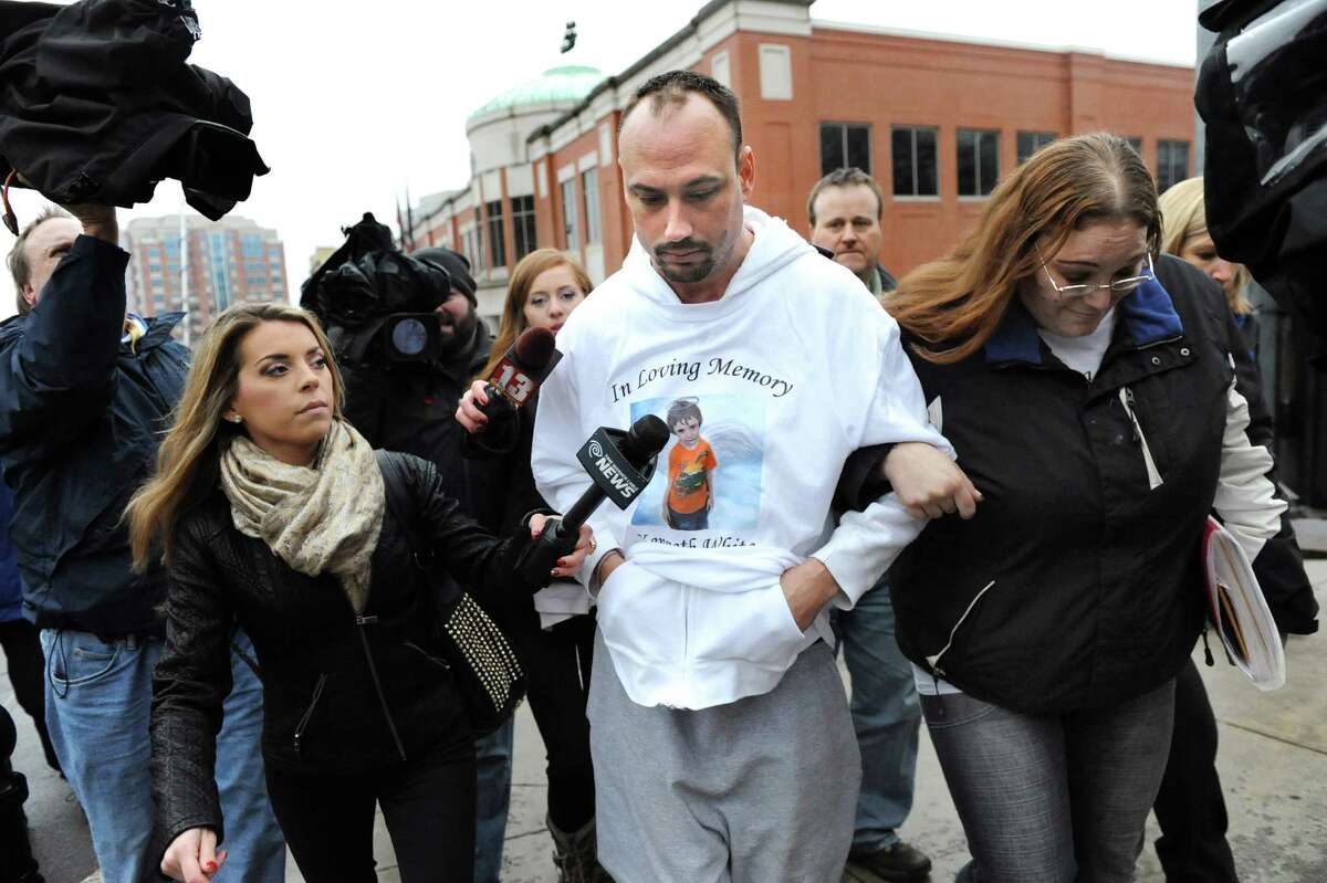 Jayson White, center, is hounded by the media after being denied custody of his two daughters, ages 5 and 4, on Tuesday Dec. 23, 2014, at Albany County Family Court in Albany, N.Y. White is the father of the late 5-year-old slaying victim Kenneth White, and the girls are Kenneth's sisters. (Cindy Schultz / Times Union)