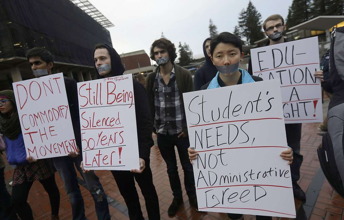 Students hold signs as they protest a series of tuition increases planned for the University of California while listening to speakers talk about the Dec. 2, 1964 Free Speech Movement demonstration outside of Sproul Hall on the UC Berkeley campus in Berkeley, Calif. on Tuesday, Dec. 2, 2014. UC officials blocked off the entrances to Sproul Hall on Tuesday to prevent students fighting the tuition hikes from staging an anniversary sit-in. (AP Photo/Jeff Chiu)