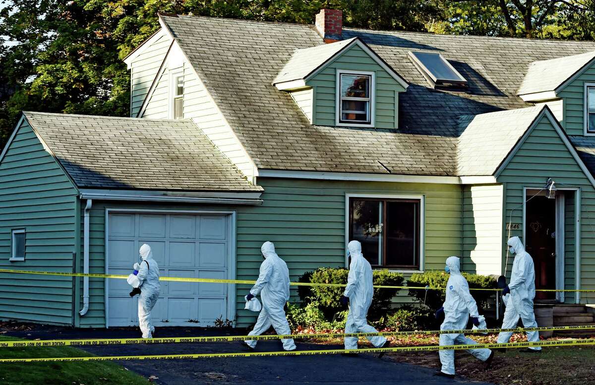 Members of the Albany County District Attorney's office prepare to enter the scene of a quadruple homicide at 1846 Western Avenue lead by acting Sr. Inv. Kelly Strack early Thursday morning Oct. 9, 2014 in Guilderland, N.Y. (Skip Dickstein/Times Union)