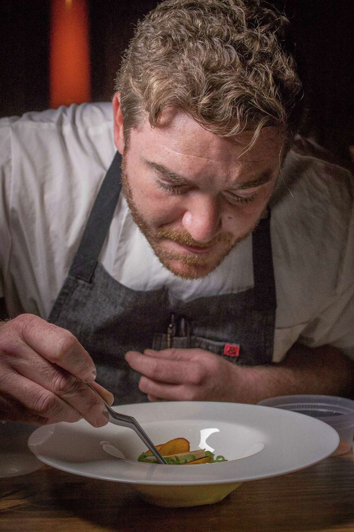 Chef David Barzelay plates the Dungeness crab course at Lazy Bear in San Francisco.