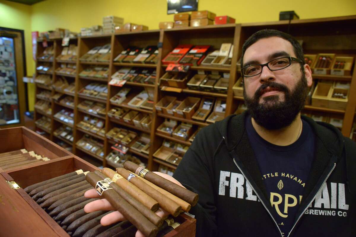 Gabriel Garcia is the owner of Cigar Pointe. He is anticipating a demand for Cuban cigars. He displays some of the finer cigars in his inventory on Tuesday, Dec. 23, 2014.