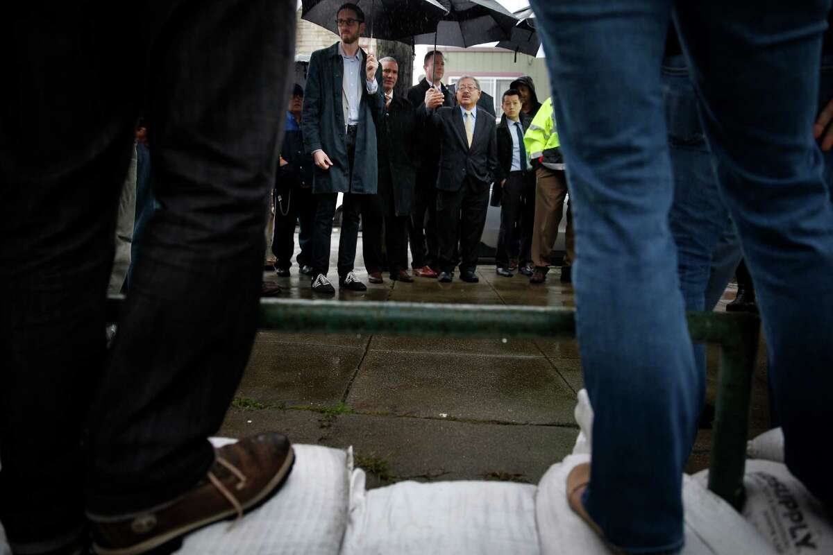 Mayor Ed Lee (second from right) and Supervisor Scott Wiener (left) meet with residents of the flooded neighborhood.