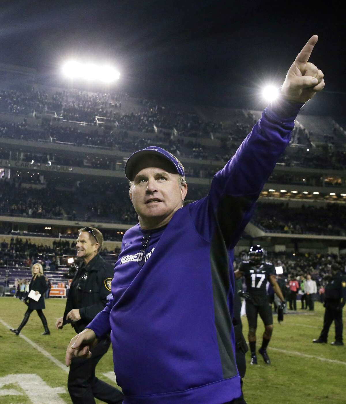 FILE - In tis Nov. 8, 2014, file photo, TCU head coach Gary Patterson points to fans as he runs off the field after an NCAA college football game against Kansas State in Fort Worth, Texas. Patterson was selected as The Associated Press college football coach of the year on Wednesday, Dec. 24, 2014. It was the second time he won the award. He also won in 2009. (AP Photo/LM Otero, File)