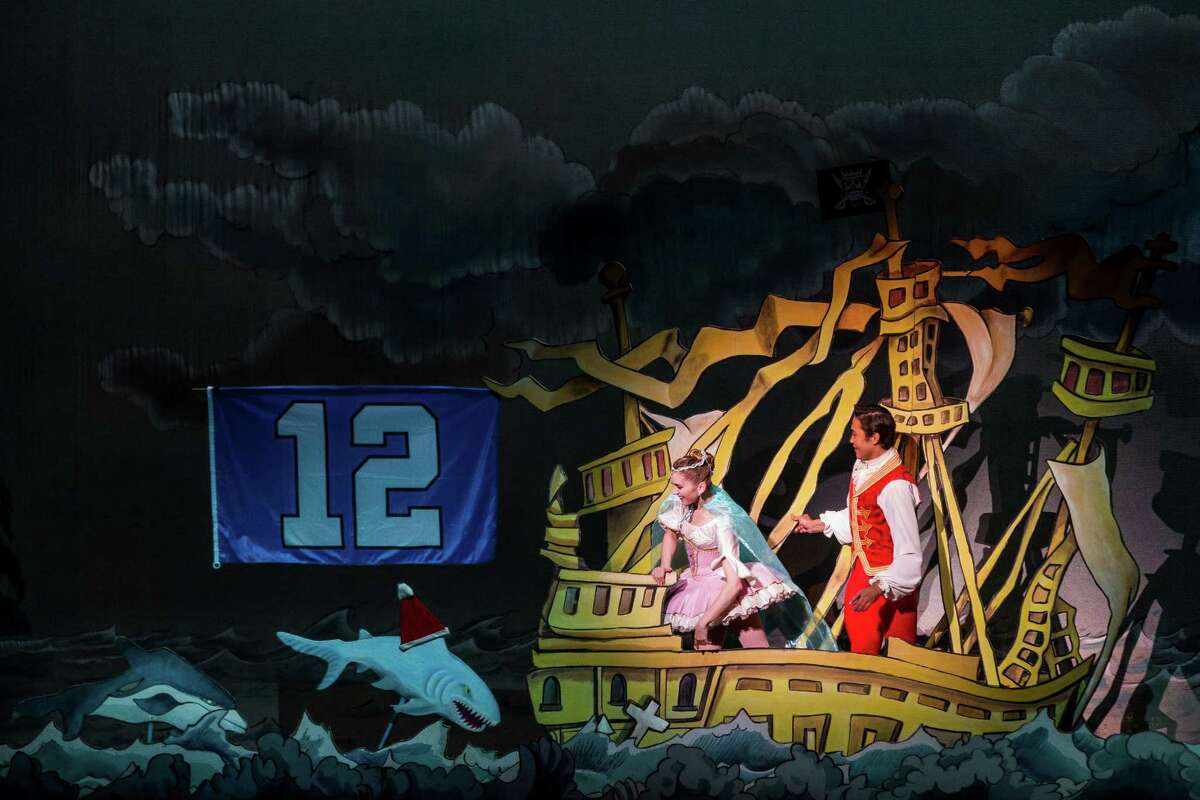 A "12th Man" flag hangs from the boat as Santa-hatted sharks circle the craft during the final, annual "nutty" Christmas Eve performance of Pacific Northwest Ballet?•s Nutcracker Wednesday, Dec. 24, 2014, at McCaw Hall in Seattle, Washington. The final showing of the Stowell and Sendak Nutcracker is Sunday, Dec. 28, 2014.