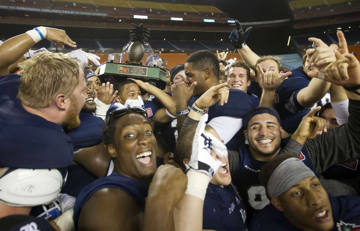 Dec. 24: Rice 30, Fresno State 6 Record: 8-5 The Rice football team hoists the Hawaii Bowl trophy after beating Fresno State in the Hawaii Bowl NCAA college football game, Wednesday, Dec. 24, 2014, in Honolulu. (AP Photo/Eugene Tanner)