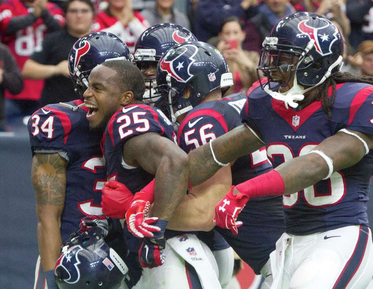 Texans cornerback Kareem Jackson celebrates with teammates after intercepting a pass against Baltimore last week.