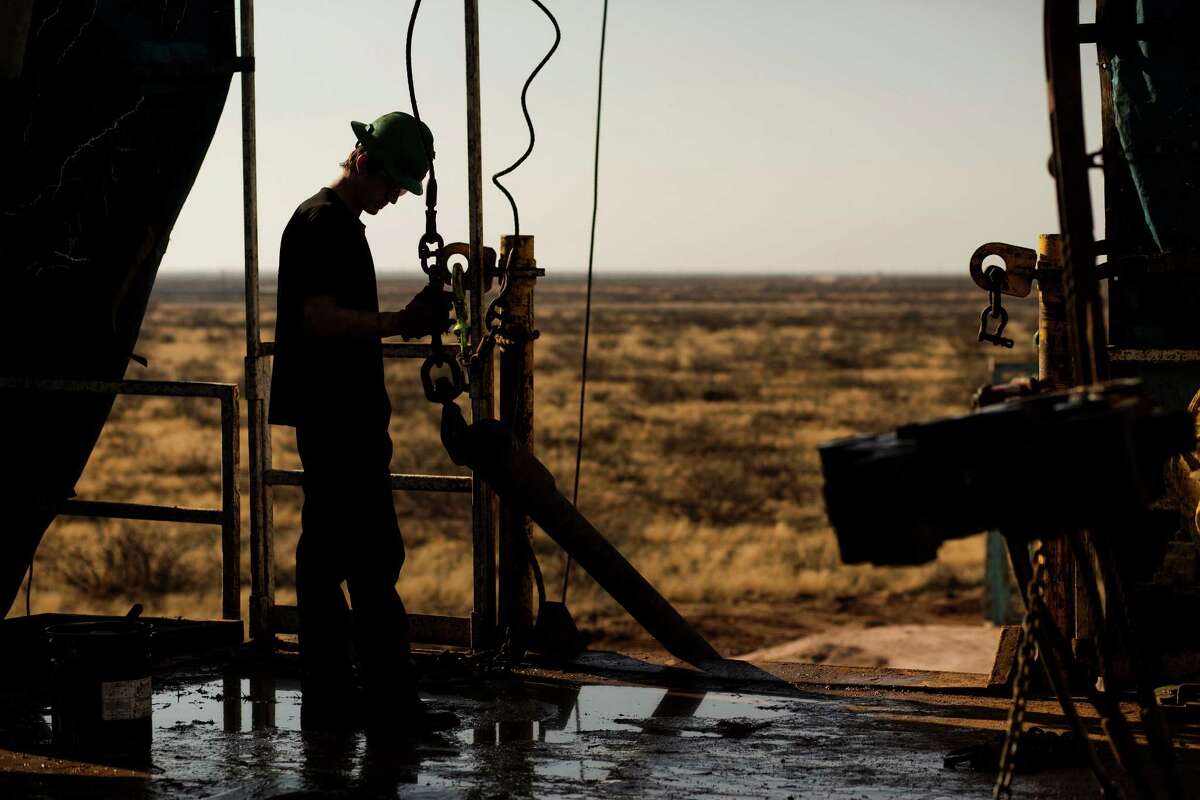 A worker waits to connect a drill bit outside Midland in the oil-rich Permian Basin of West Texas, which has enjoyed a boom that is turning sour as oil prices fall. In December, the state had a record 311,400 upstream oil and gas workers﻿. ﻿
