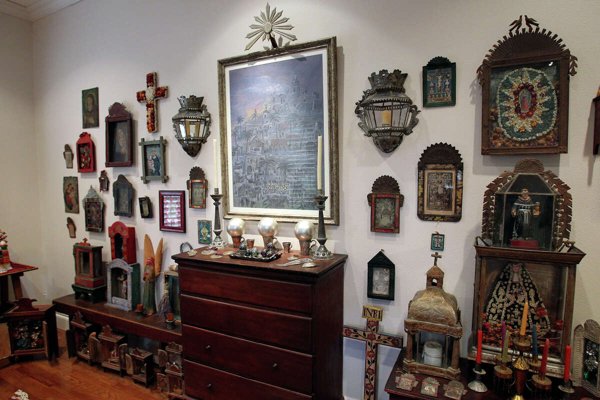 Margaret and Fred Schellenberg bought their house with their vast collection of Mexican folk art in mind. She grouped nichos on the wall, furniture and floor of the front room.