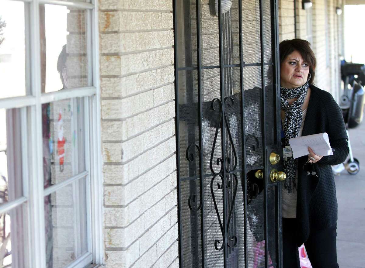 In this photo taken on Dec. 16, 2013, El Paso Independent School District Student Outreach Specialist Donna Franco knocks on an apartment door as she searches for a child who has not been attending school in El Paso, Texas (AP Photo/The El Paso Times, Mark Lambie).