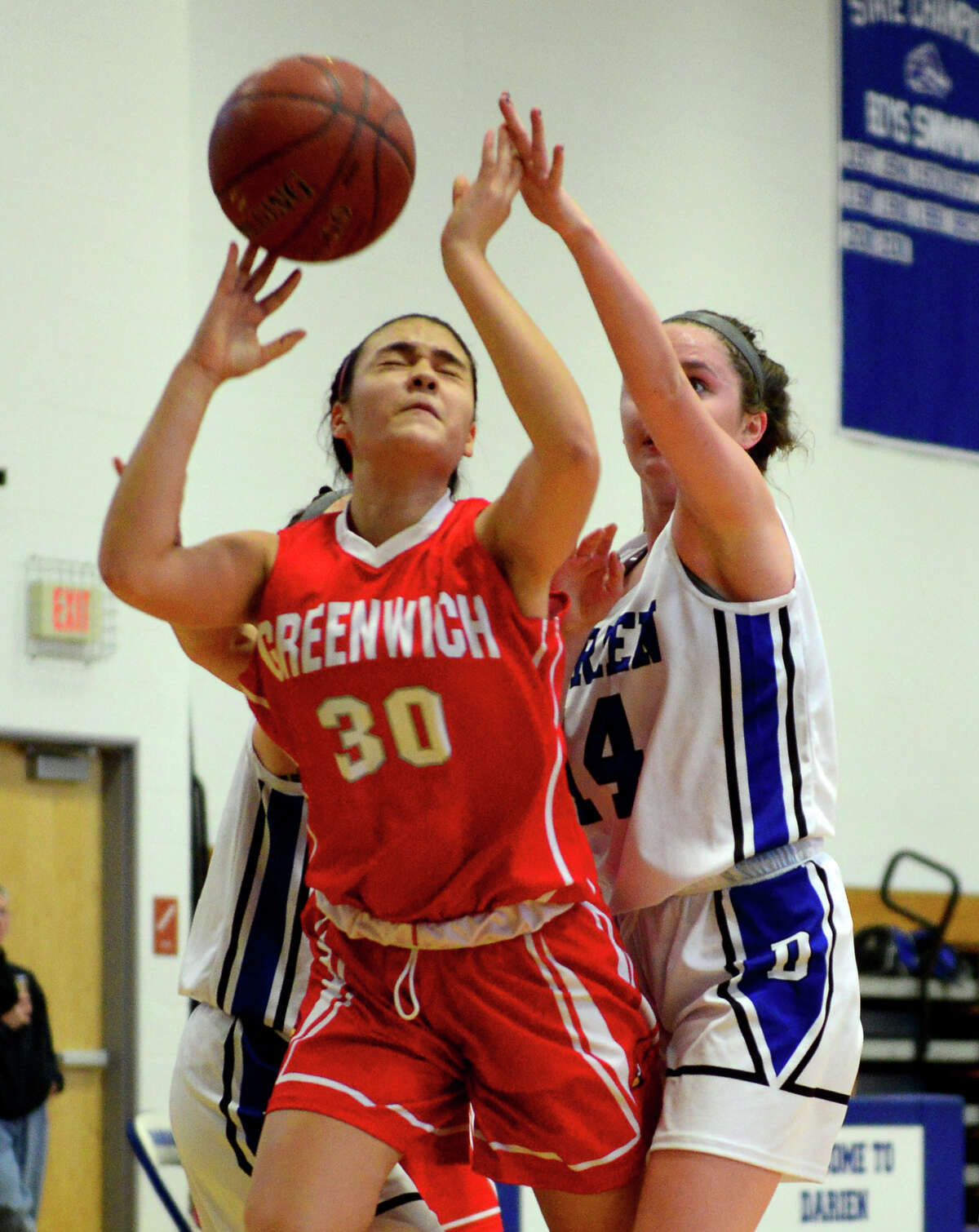 Darien's Emily Coyle, right, disrupts a shot attempt by Greenwich's Kimberly Kockenmeister, during Tony LaVista Basketball Tournament action in Darien, Conn. on Saturday Dec. 28, 2014.