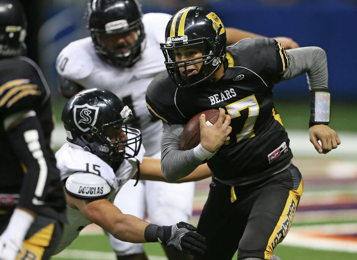 Bear quarterback Da'Shawn Key grinds into the Knight defense in the second half as Steele plays Brennan at the Alamodome in second round 6A high school Division I I playoff action on November 22, 2014.