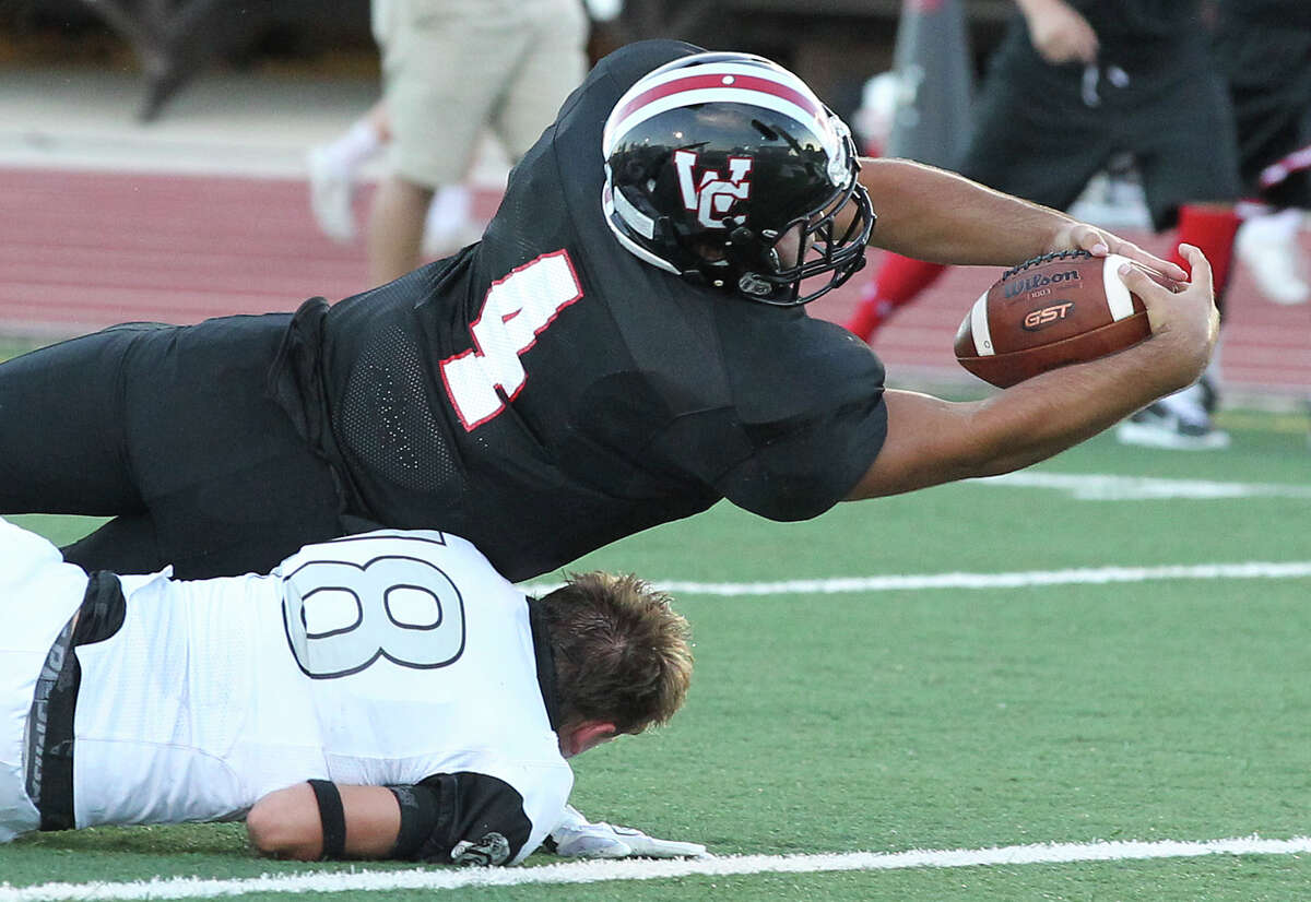 Churchill running back Nick Smisek stretches the ball across the goal line for a touchdown over Kyle Dudney at Comalander Stadium on Aug. 28, 2014.