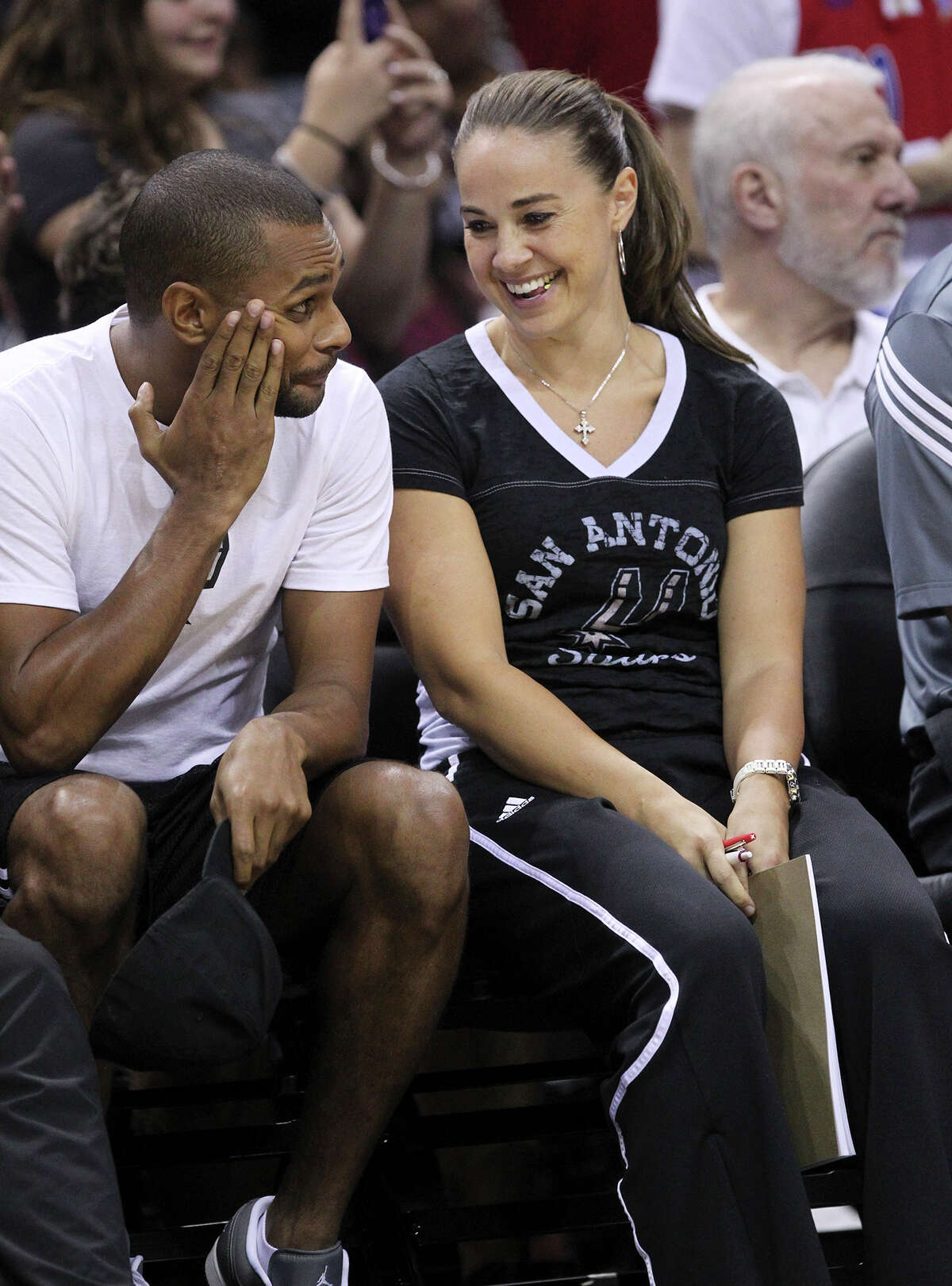 Assistant coach Becky Hammon jokes with Patty Mills during the Spurs’ public practice at the AT&T Center on Oct. 1, 2014.