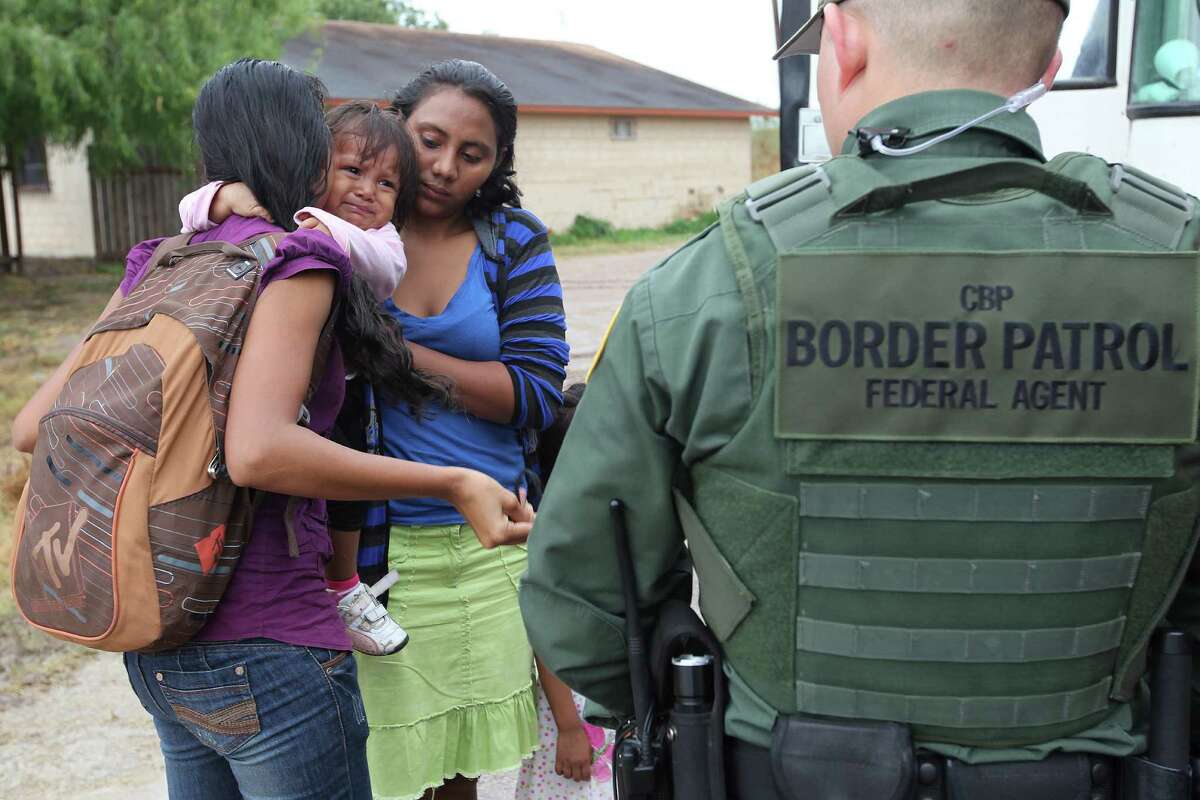An infant cries as U.S. Border Patrol agents process a group of immigrants in Granjeno, Texas. The city is just north of �El Rincon del Diablo,� the Devil�s Corner, a hotbed of illegal border crossing on the Rio Grande. The area has experience a wave of illegal crossings by Central American juvenile and mothers with children immigrants.