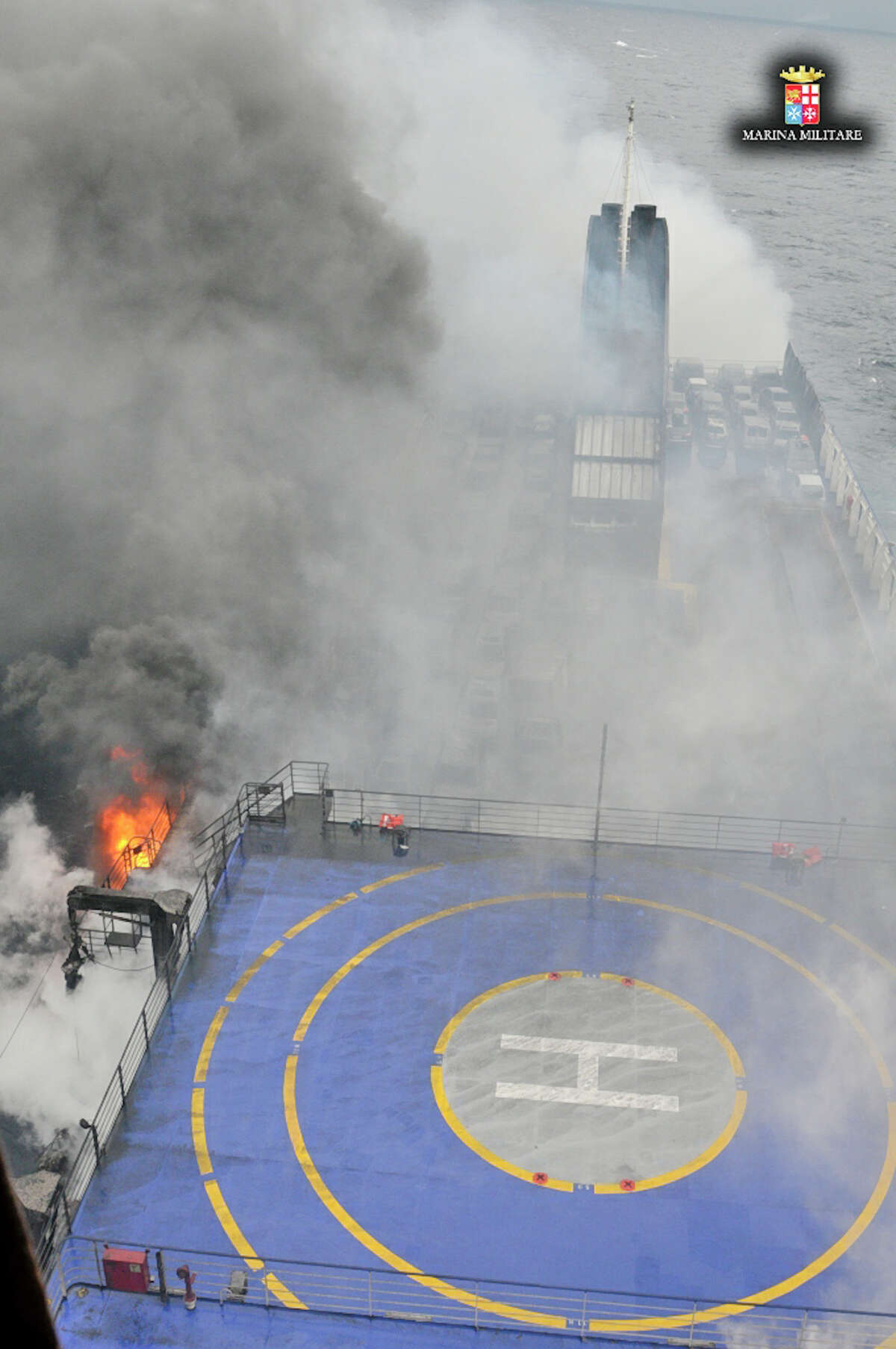 In this image released by the Italian Navy, smoke billows from the Italian-flagged ferry Norman Atlantic that caught fire in the Adriatic Sea, Sunday, Dec. 28, 2014. Italian and Greek rescue crews battled gale-force winds and massive waves as they struggled Sunday to evacuate hundreds of people from a ferry on fire and adrift in the channel between Italy and Albania. At least one person died and two were injured. The fire broke out before dawn Sunday on a car deck of the Italian-flagged Norman Atlantic, traveling from the western Greek port of Patras to the Italian port of Ancona on the Adriatic, with 422 passengers and 56 crew members on board.AP story: 1 dead, hundreds stranded in Greek ferry disaster