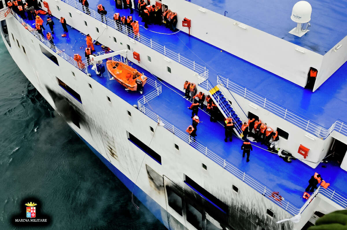 In this image released by the Italian Navy, passengers and crew are seen on the deck of the Italian-flagged ferry Norman Atlantic that caught fire in the Adriatic Sea, Sunday, Dec. 28, 2014. Italian and Greek rescue crews battled gale-force winds and massive waves as they struggled Sunday to evacuate hundreds of people from a ferry on fire and adrift in the channel between Italy and Albania. At least one person died and two were injured. The fire broke out before dawn Sunday on a car deck of the Italian-flagged Norman Atlantic, traveling from the western Greek port of Patras to the Italian port of Ancona on the Adriatic, with 422 passengers and 56 crew members on board.AP story: 1 dead, hundreds stranded in Greek ferry disaster