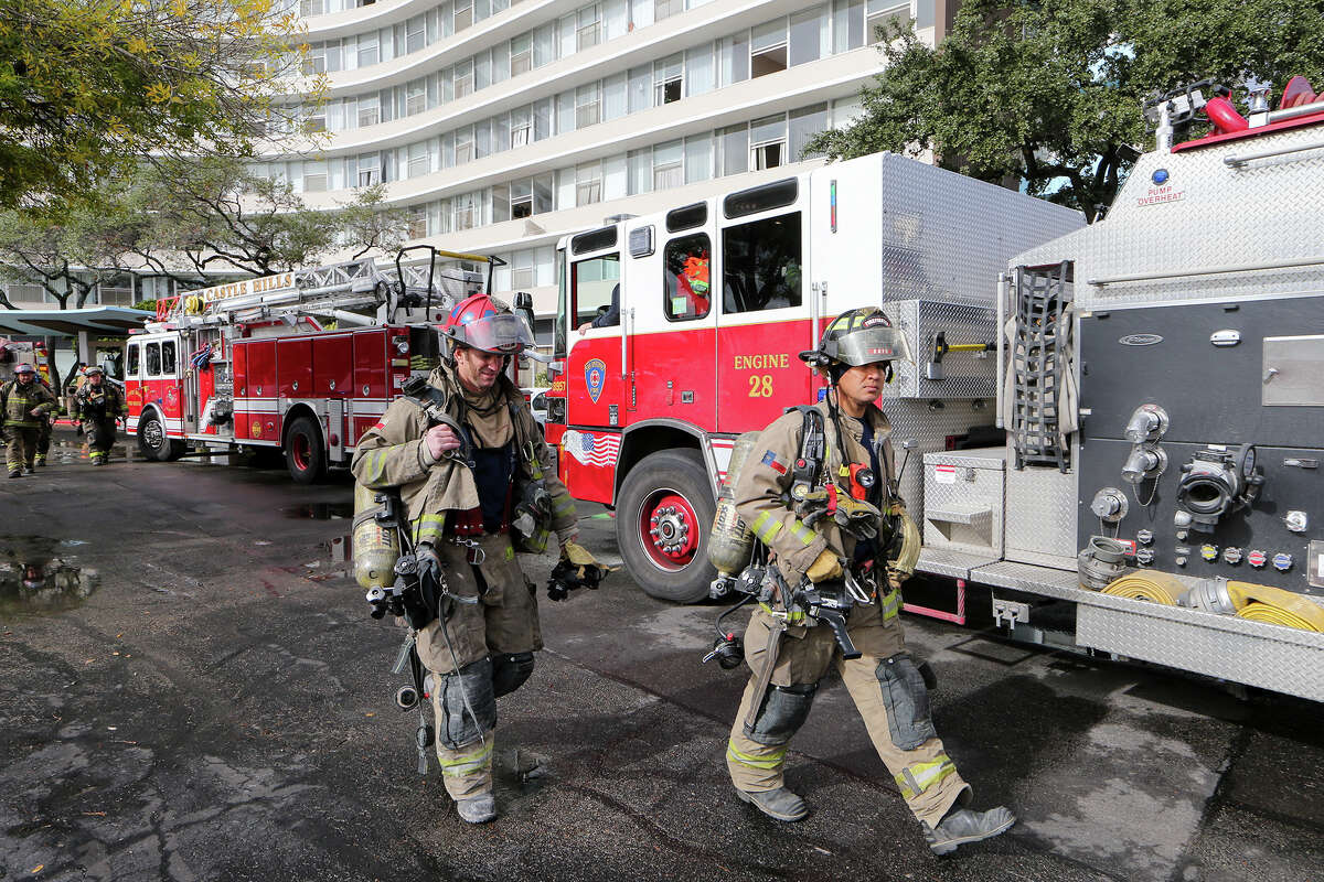 Firefighters and emergency units prepare to leave from a three-alarm fire at the Wedgwood Senior Apartments, 6701 Blanco Rd., on Sunday, Dec. 28, 2014. The early morning fire, which started shortly after 6:00 a.m., claimed the lives of five people. Three others were taken to the hospital and approximately 75-100 residents were evacuated to Churchill High School. MARVIN PFEIFFER/ mpfeiffer@express-news.net
