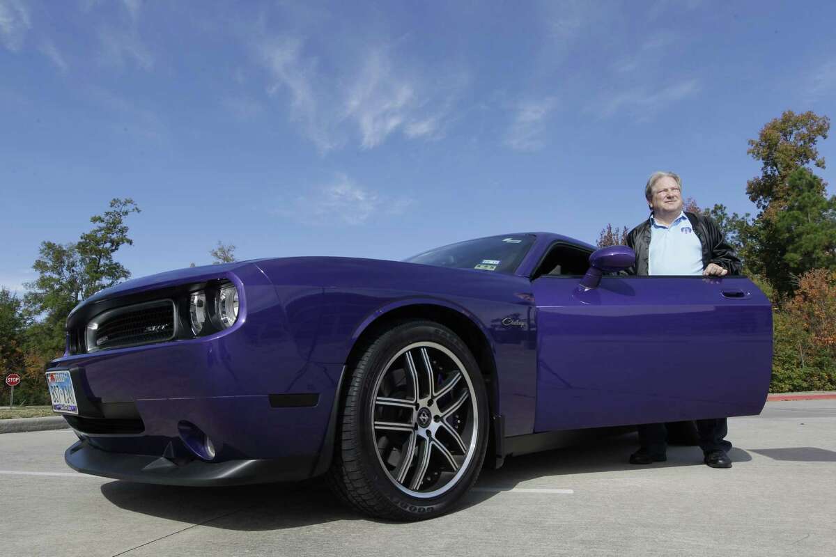 Mike Grieco poses with his 2010 Dodge Challenger SRT8 Tuesday, Nov. 25, 2014, in Spring. The purple color is know as Plum Crazy Challenger. ( Melissa Phillip / Houston Chronicle )