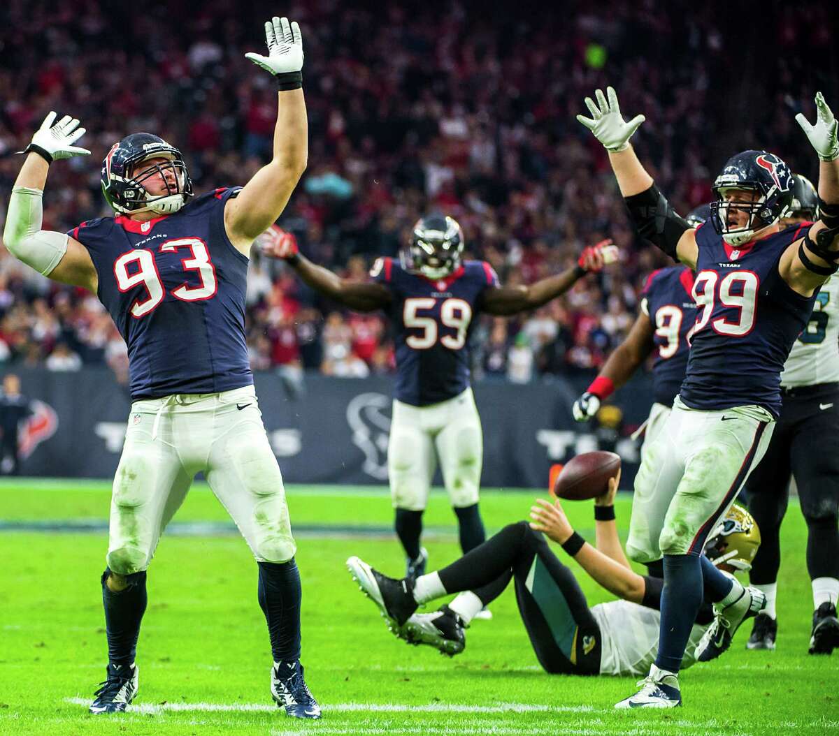 Defensive end Jared Crick (93) celebrates with J.J. Watt (99) after sacking Blake Bortles in the second half Sunday. Crick said the 9-7 record was bittersweet because the Texans failed to make the playoffs.