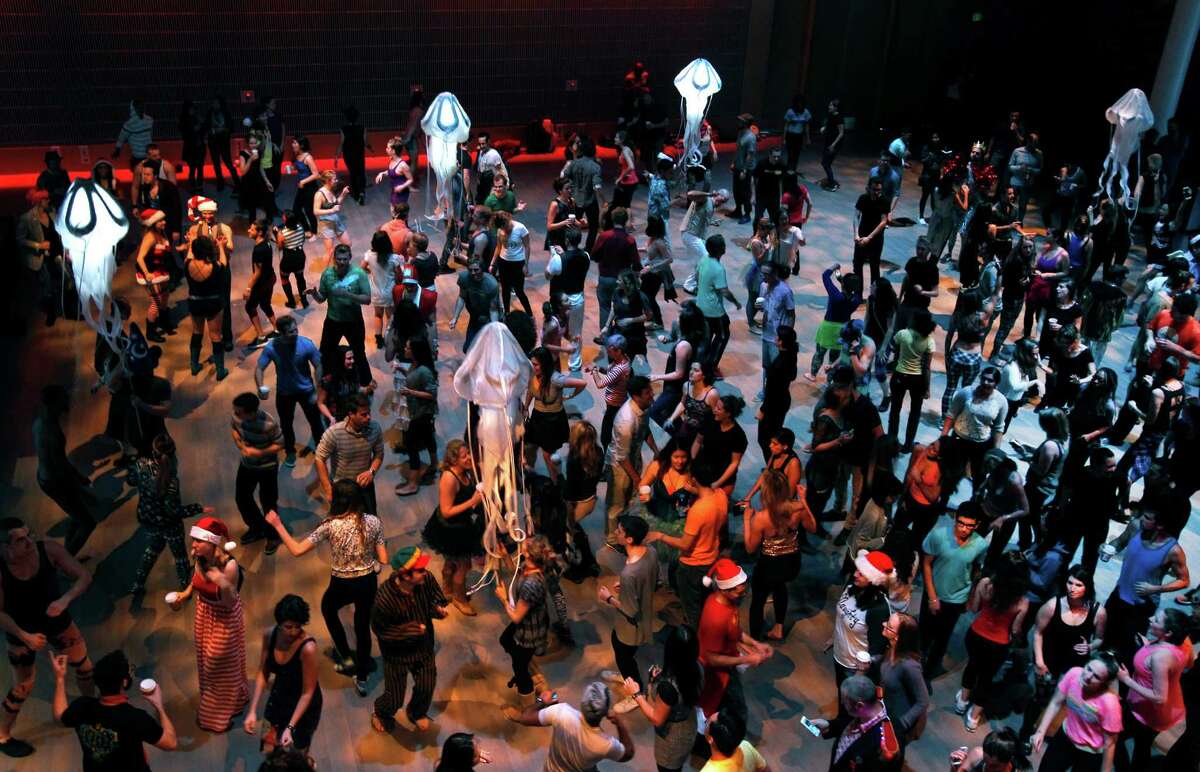 At Yerba Buena Center for the Arts, a crowd dances at an early morning party presented by Daybreaker, one of two firms hosting morning dance events.