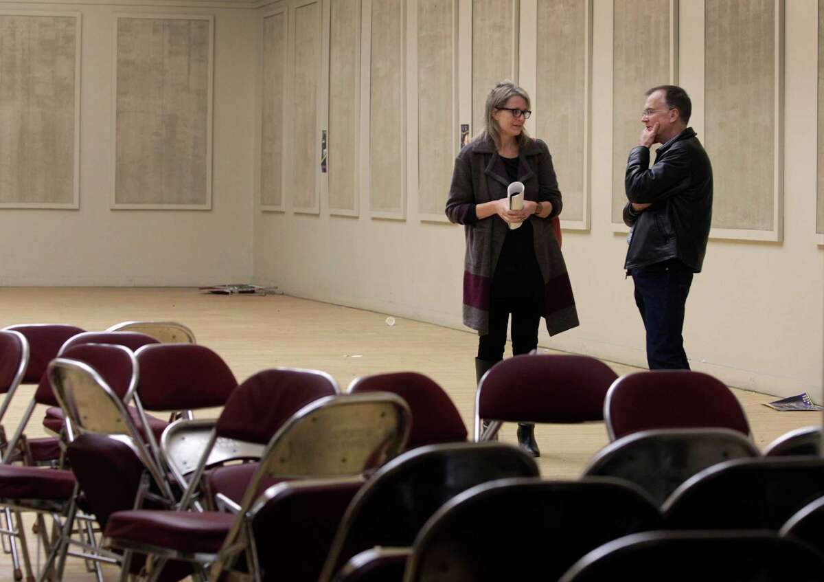 Kelley Kahn (left), an urban planner who is overseeing the restoration project, tours the center’s Gold Ballroom with Jens Hillmer. 215,000-square-foot building would house some combination of entertainment venues, offices, retail and restaurant space, and become a focal point for the Lake Merritt area, said urban planner , who is overseeing the project for the city. Kelley Kahn and Jens Hillmer tour the Gold Ballroom at the Henry J. Kaiser Convention Center in Oakland, Calif. on Friday, Nov. 21, 2014. Oakland city officials are looking at bids from developers for the historic arena and theater site across from Lake Merritt which has been shuttered since 2005.