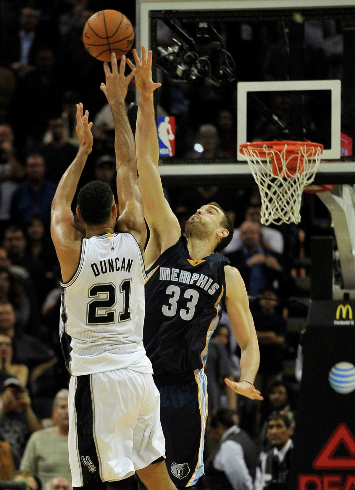 Spurs forward Tim Duncan sinks a basket over Memphis Grizzlies center Marc Gasol in the second overtime period, to send the game into triple overtime on Dec. 17, 2014, in San Antonio.