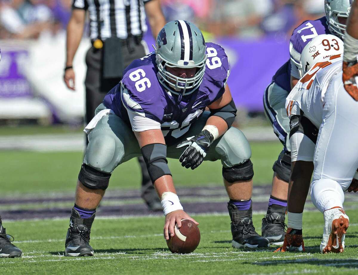 MANHATTAN, KS - OCTOBER 25: Center B.J. Finney #66 of the Kansas State Wildcats gets set to snap the ball against the Texas Longhorns during the second half on October 25, 2014 at Bill Snyder Family Stadium in Manhattan, Kansas.