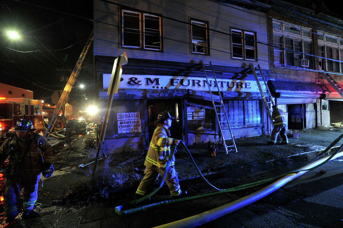 Firefighters were called to the scene at Manhattan and Garden Streets for a fire in a former furniture store in Stamford, Conn., on Monday, Dec. 29, 2014.