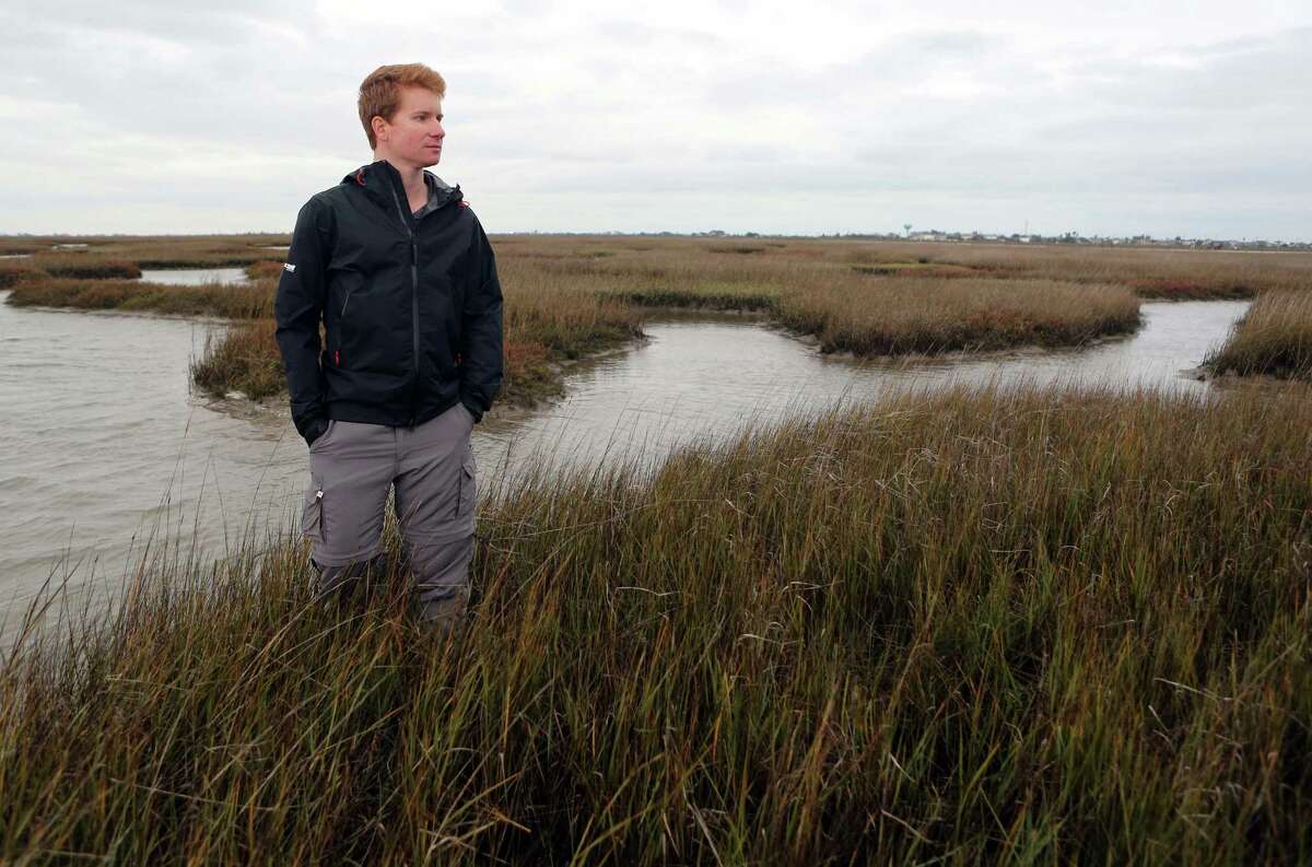 Nathan Johnson, Habitat and Stewardship Program Manager at Artist Boat Inc., walks through the wetland area of the Gulf Coast Preserve that has been acquired by Artist Boat Inc. with a help of a grant on Tuesday, Dec. 23, 2014, in Galveston. , The 600 acres of preserve habitat will be protected from development on Galveston Island. ( Mayra Beltran / Houston Chronicle )