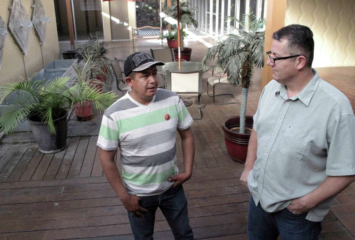 Farmworker Severiano Salas (left) speaks with United Farm Workers National Vice President Armando Elenes in Fresno. Farmers worry Obama’s executive order could deplete their workforce.
