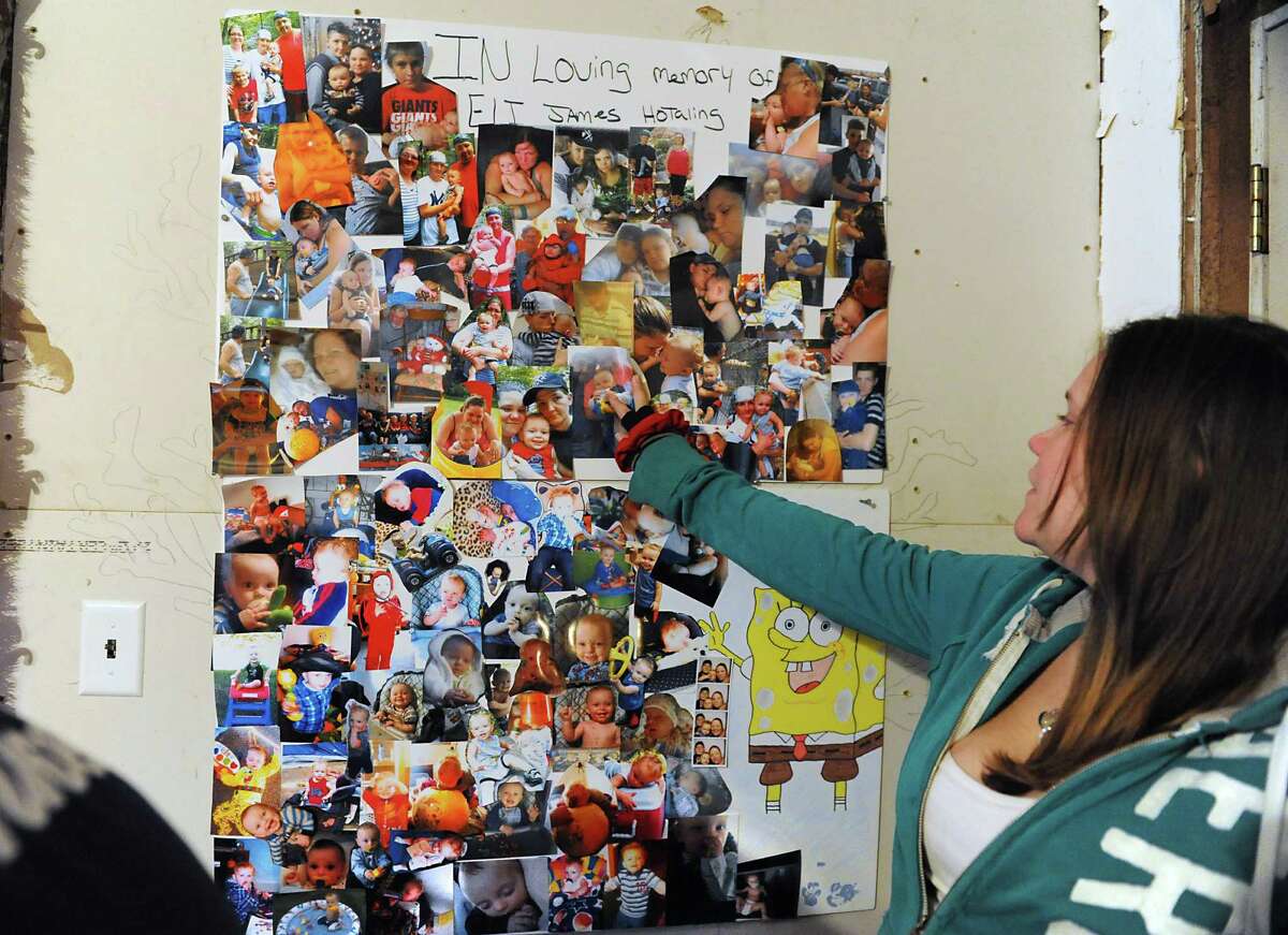 Alyssa Hotaling looks at a photo collage of her son Eli James Hotaling onTuesday, Dec. 23, 2014 in Canajoharie, N.Y. Eli died Dec. 9 after consuming liquid nicotine. (Lori Van Buren / Times Union)