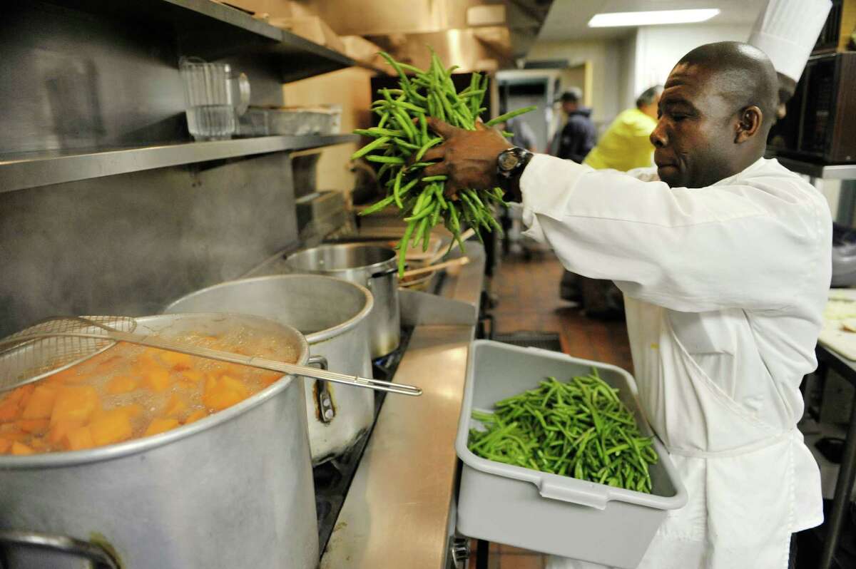 Kinnmo Ngoran, assistant chef, cooks string beans as staff and volunteers prepared lunch at Capital City Rescue Mission on Monday, Dec. 29, 2014, in Albany, N.Y. Representatives from SEFCU traveled around the Capital Region on Monday to deliver checks totaling $132,500 to rescue missions and food pantries. The Capital City Rescue Mission received $15,000. This is the fifth year that SEFCU has given out checks to the organizations. (Paul Buckowski / Times Union)