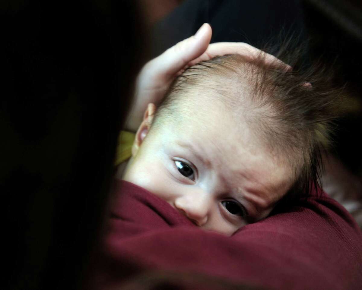 Sandra Losito, 34, of Bethel, Conn., breastfeeds her son, Joey, 3-months-old, Tuesday afternoon, Dec. 30, 2014. Losito is the mother of three - all were breastfed as babies.