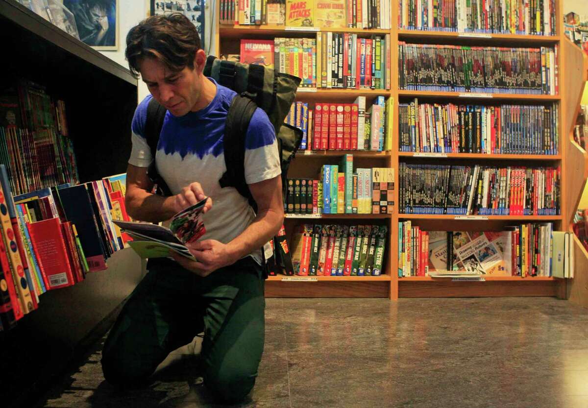 Dennis Budd of San Francisco picks out comic books at Comix Exchange on Divisadero Street in San Francisco, Calif. Wednesday, December 24, 2014.