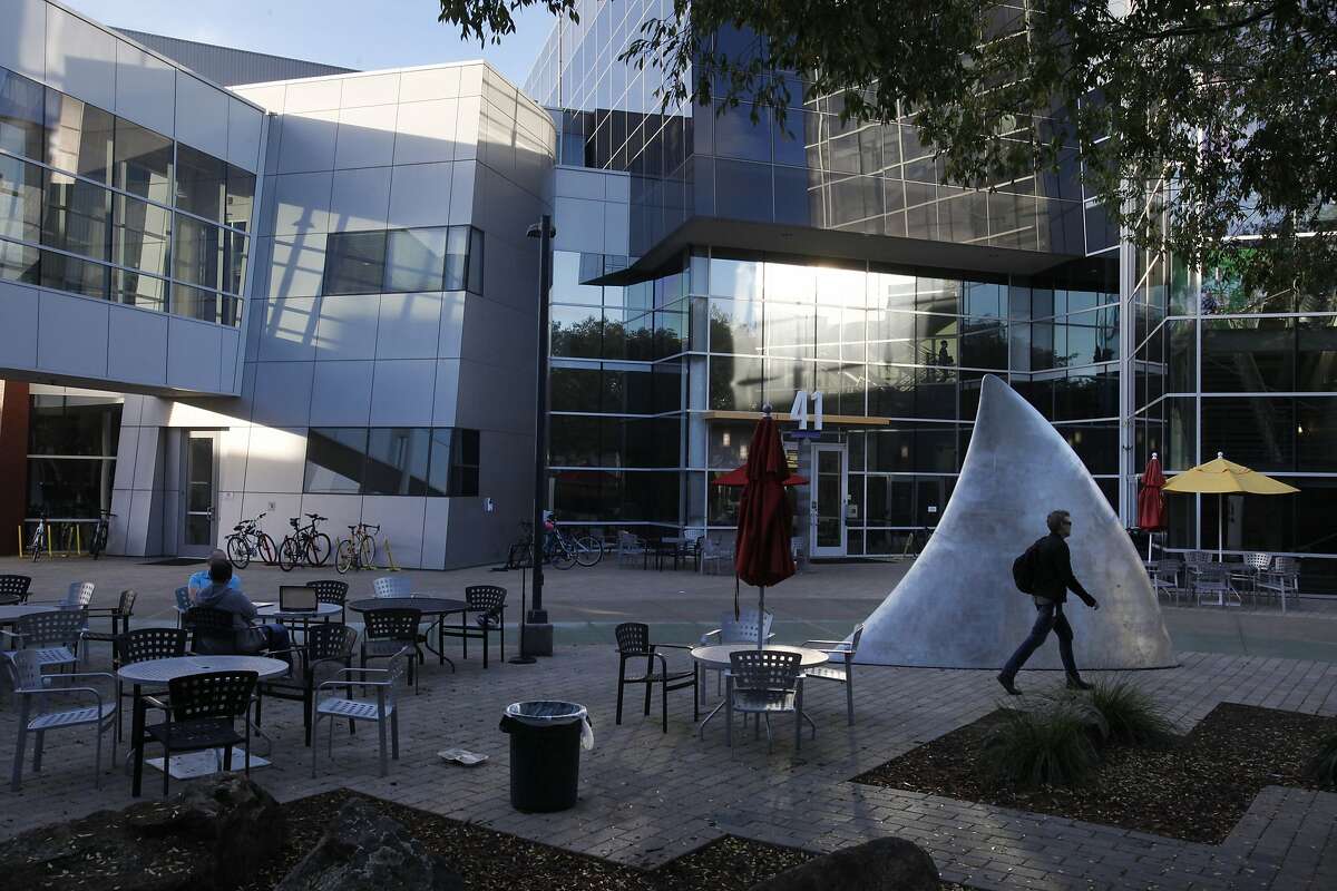 A man walks past a shark fin that was once taken to Burning Man on Google's Mountain View headquarters Dec. 4, 2014 in Mountain View, Calif.