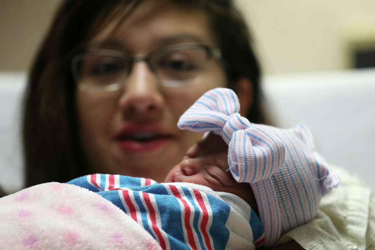 Melody Esparza holds her daughter, Sarah Allison Gutierrez at Methodist Hospital, Thursday, Jan. 1, 2015. Sarah Allison was the first baby born in the new year in the San Antonio area. She was born at 12:02 a.m. The baby received various gifts from area hospital and a $10,000 scholarship to The Incarnate Word University.