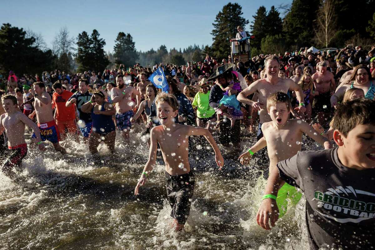 Hundreds of brave souls charged into the frigid waters of Pontiac Bay during the 13th Annual Polar Bear Plunge  at Matthews Beach Park.