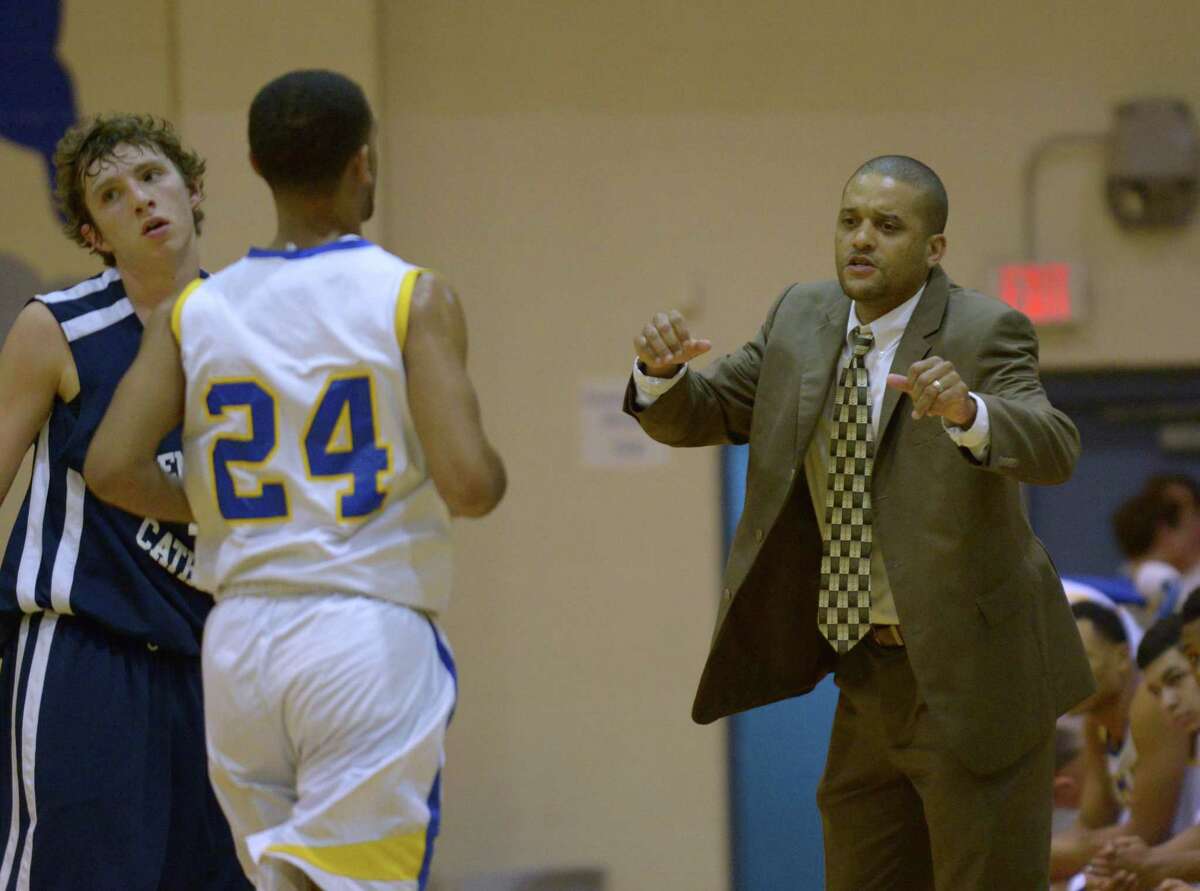 Clemens coach Clifton Ellis talks to Sam Kearns as he comes off the floor during a nondistrict game against Central Catholic on Nov. 29, 2014.