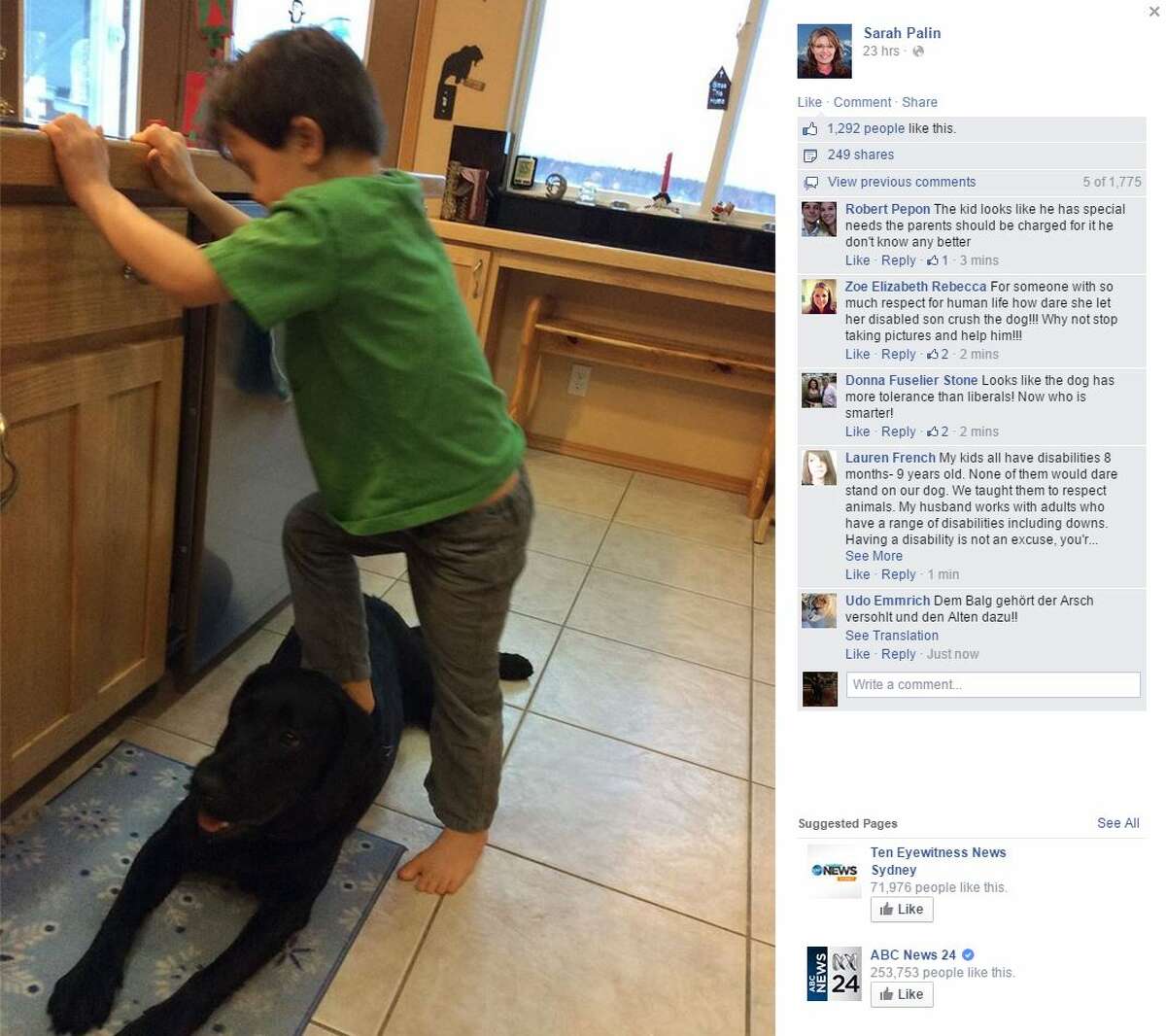 Sarah Palin, former Republican vice presidential candidate, has drawn outrage over a New Year's Day Facebook post showing her son Trig standing on the family dog.