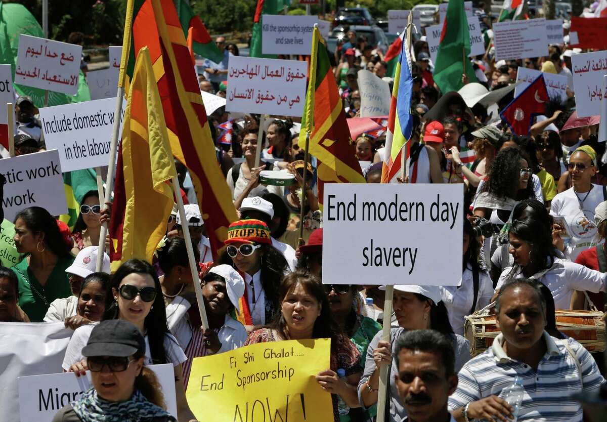 Migrant domestic workers hold posters demanding the same basic labor rights as that of the Lebanese workers during a 2013 march in Beirut.