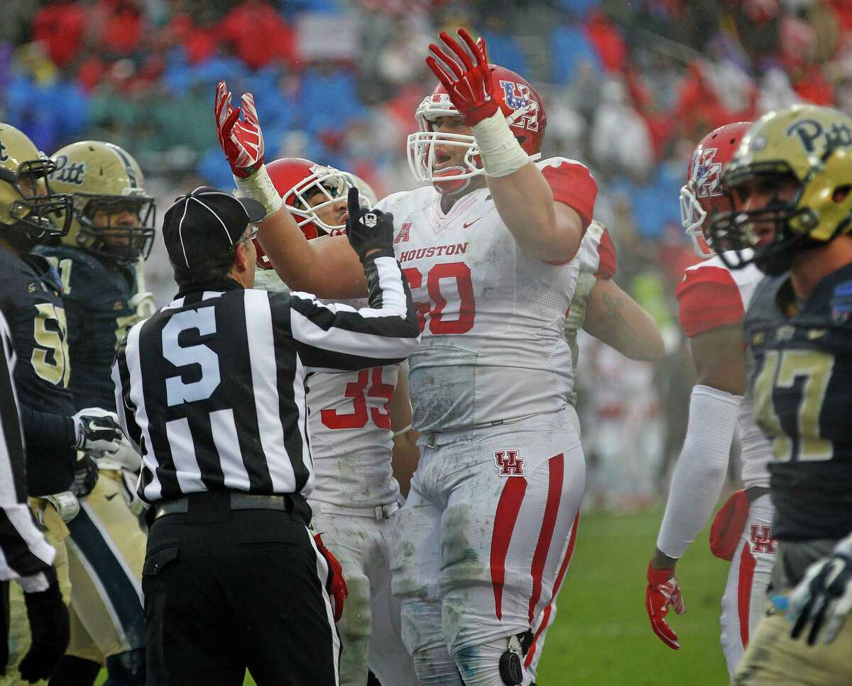 Houston Cougars offensive lineman Alex Cooper (60) celebrates a Cougar touchdown in the first half Friday at Amon G. Carter Stadium. The Houston Cougars played the Pittsburgh Panthers in the Armed Forces Bowl Friday January 2, 2015 in Fort Worth, Texas.
