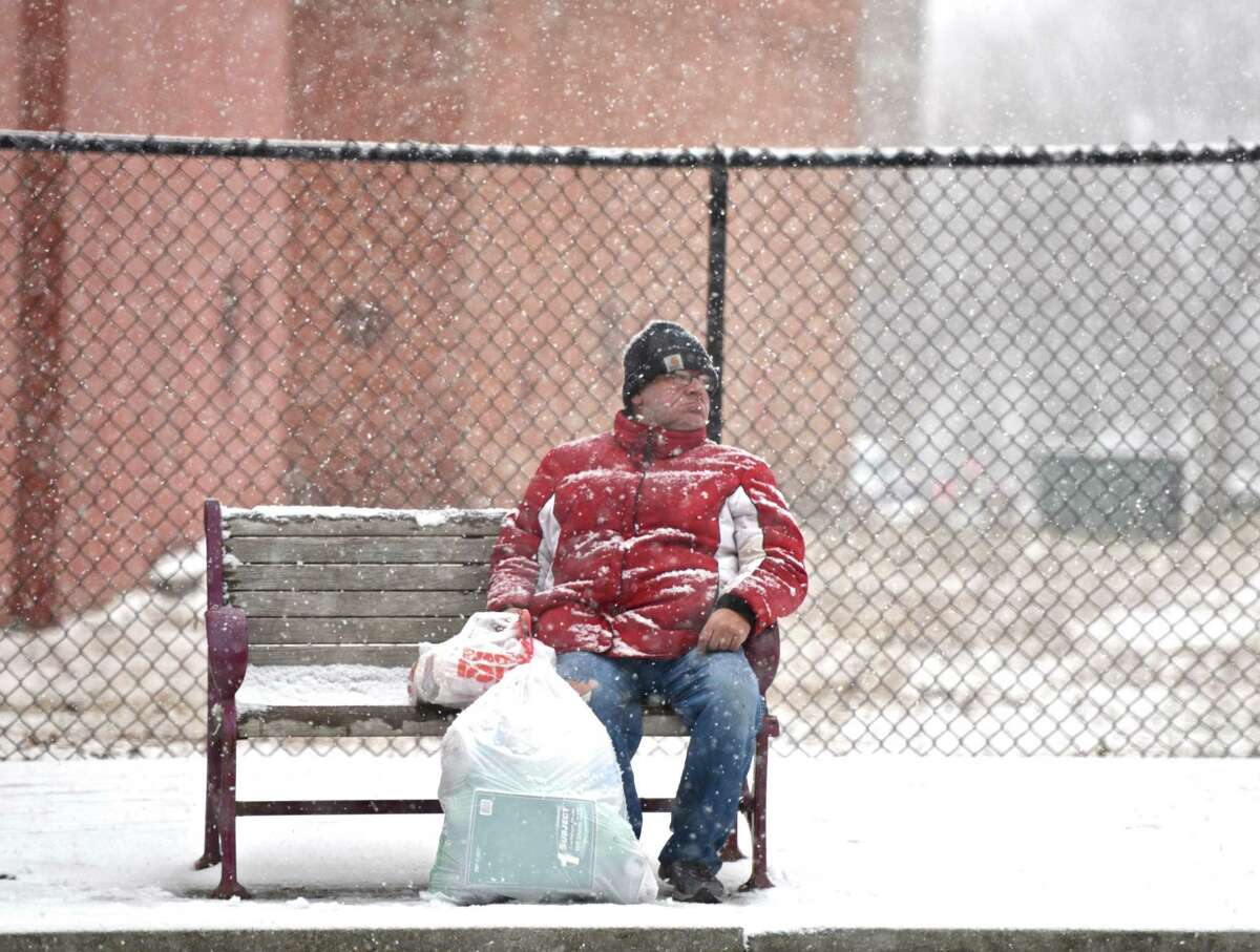 Larry Keeler, 62, of Danbury, waits patiently for his bus, along Main Street, during an afternoon snow storm in Danbury, Conn, on Saturday, January 3, 2015.